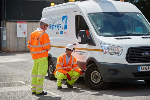 Highways workers next to a van